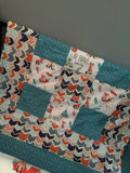 Patchwork Baby Blanket in turquoise and orange with a modern woodland look with foxes, arrows and a broken chevron in Orange, turquoise