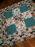 Patchwork Baby Blanket in turquoise and orange with a modern woodland look with foxes, arrows and a broken chevron in Orange, turquoise