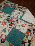 Patchwork Baby Blanket in turquoise and orange with a modern woodland look with foxes, arrows and a broken chevron in Orange, turquoise