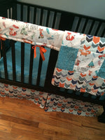 Patchwork Baby Blanket in turquoise and orange with a modern woodland look with foxes, arrows and a broken chevron in Orange, turquoise
