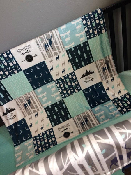 Baby Boy Double Minky Baby blanket in navy, mint and gray with a woodland theme incorporating deer, arrows, canoes, antlers and mountains