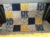 Where the Wild Things Are inspired crib bedding set in navy, gray and a golden yellow with woodland fabrics of arrows, crowns, tans trees