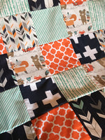 READY TO SHIP - Patchwork blanket with a modern woodland theme including foxes and bears, trees, and arrows in orange, navy, and mint