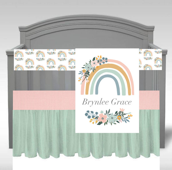Baby Girl Crib Bedding Set with a rainbow theme in pink, mint and yellow with a personalized blanket with a boho floral rainbow