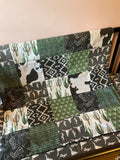 Made to Order Baby Bedding with a western boho theme with cactus, cow, and Aztec prints in dark green, gray and black