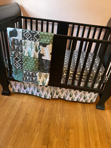 Made to Order Baby Bedding with a western boho theme with cactus, cow, and Aztec prints in dark green, gray and black
